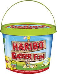 A plastic bucket with a green lid and handle, labelled “Haribo Easter Fun.” The container is decorated with colourful Easter-themed graphics, including cartoon bunnies, chicks, and eggs, and features the Haribo bear mascot in the bottom left corner.