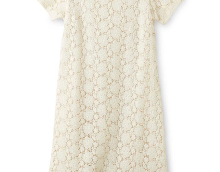 A short-sleeved, knee-length cream dress with a round neckline. The dress features an overall floral lace pattern, with a visible light lining underneath, giving it a delicate and elegant appearance. It is laid flat on a white background.