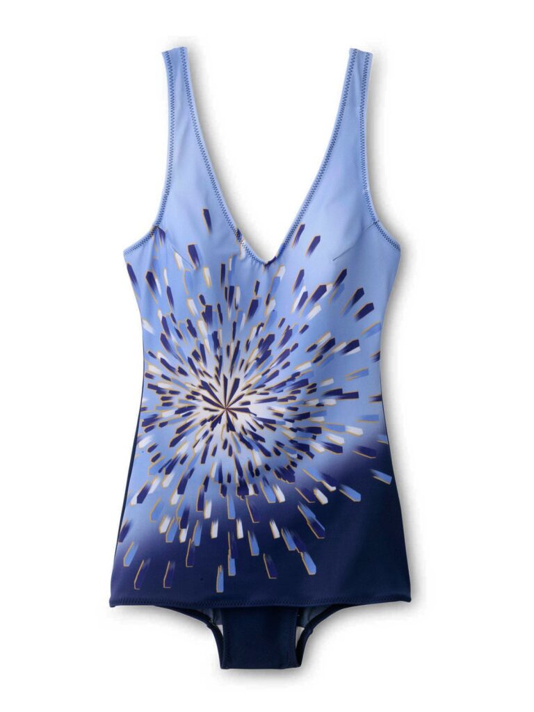 A one-piece swimming costume with a deep V neckline, featuring a blue gradient background. The front displays a dynamic, radial burst pattern in shades of white, light blue, and navy, resembling a fireworks explosion or sunburst effect.