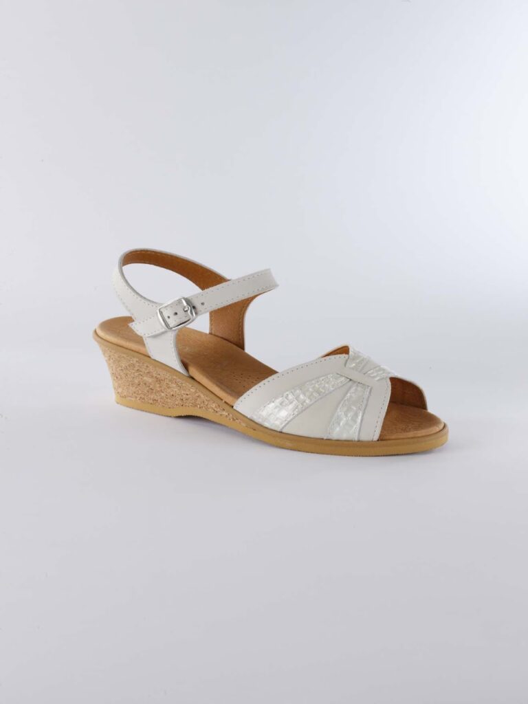 A single white wedge sandal with a cork sole, ankle strap with a silver buckle, open toe, and decorative shimmery accents on the straps, displayed against a plain light background.