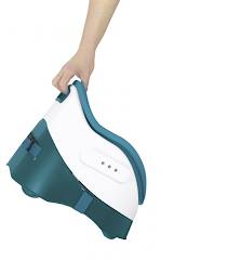 A hand holds a compact, portable booster seat with a curved blue and white design. The seat features a handle for carrying and buckles on the side for securing it, indicating it is lightweight and designed for easy transport. The background is white.
