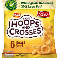 A yellow bag of Walkers Hoops and Crosses baked snacks, roast beef flavour. The front shows the product name, nutrition claims like "wholegrain goodness" and "30% less fat," and an image of X and O-shaped snacks. The packet contains 6 packs.