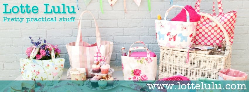 A pastel-themed display featuring floral and striped tote bags, a picnic hamper with fabric liners, teacups, flowers, cupcakes, and bunting against a light brick wall. Text reads “Lotte Lulu, Pretty practical stuff” and “www.lottelulu.com”.