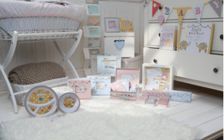 A cosy, white nursery with a wicker bassinet, a fluffy rug, and a chest of drawers. Pastel baby gifts, keepsake boxes, plates, and decor with elephant designs are arranged on the floor. Colourful bunting and cards hang on the chest of drawers and wall.