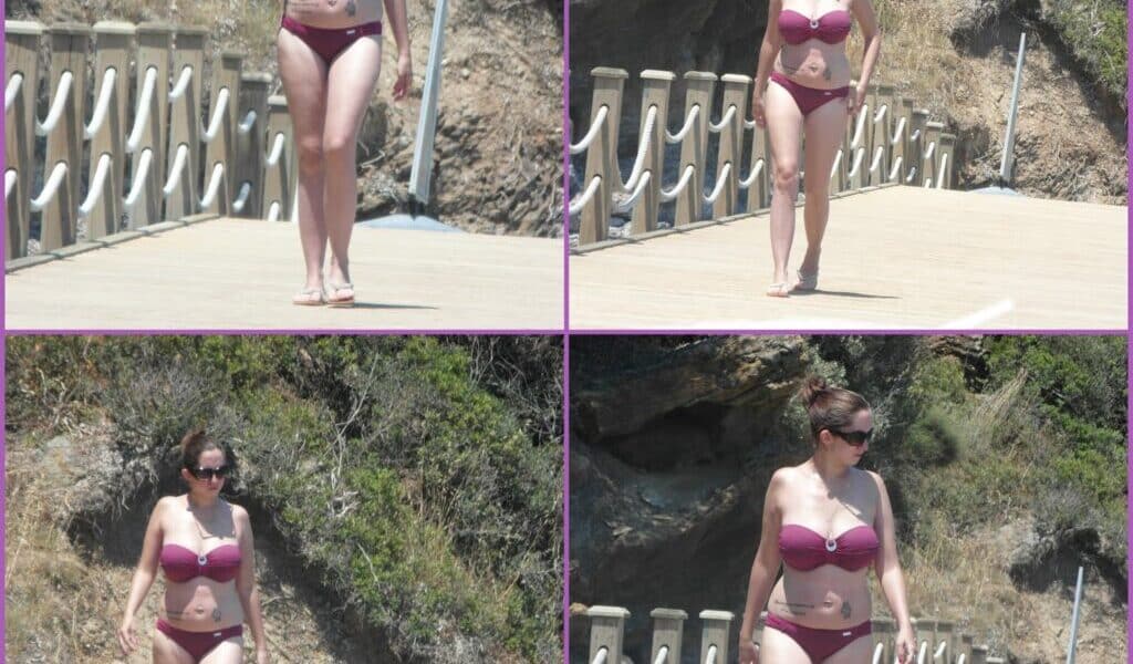 A woman wearing a mauve bikini and sunglasses walks barefoot on a wooden jetty surrounded by rocky cliffs and greenery. The image is a four-photo collage showing her in various walking poses under bright sunlight.