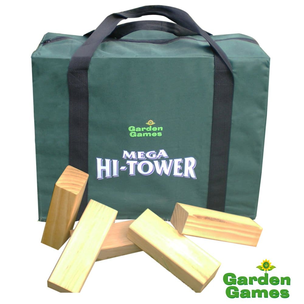 A green carrying bag labelled “Garden Games Mega Hi-Tower” sits upright. In front of it are five large, rectangular wooden blocks, some stacked and some lying flat, hinting at a giant outdoor Jenga-style game. The Garden Games logo is in the bottom right corner.