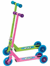 Two colourful children's scooters are shown. One scooter is green with blue and purple handles, the other is pink with purple and blue handles. Both have three blue wheels and cartoonish designs on the decks. The scooters are arranged side by side.