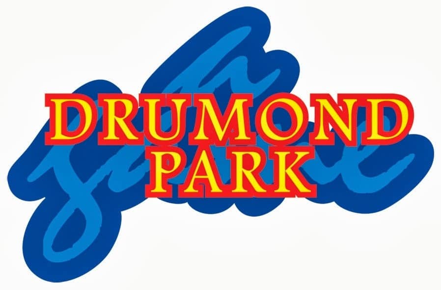 The Drummond Park logo features bold yellow "DRUMOND PARK" text with red outlines, centred over a thick, blue, stylised script background on a white backdrop.