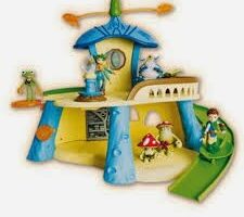 Colourful toy playset resembling a whimsical house with blue columns, yellow walls, green slide, and cartoon character figurines, including fairies and animals, placed around the structure, evoking a magical, storybook atmosphere.