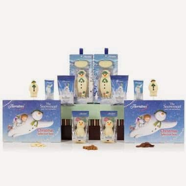 Assorted “The Snowman” themed Christmas chocolate gift sets featuring boxes, chocolate bars, snowman-shaped sweets, and mugs, all decorated with illustrations of the Snowman character from the classic Christmas story, arranged in a festive display.