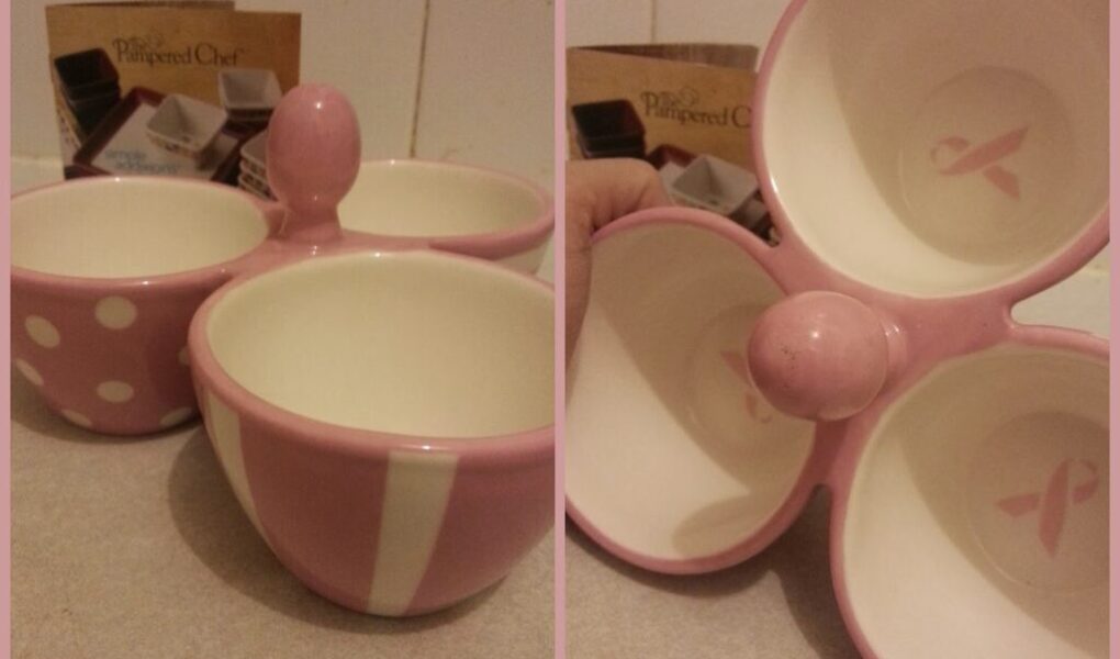 Two images show a pink ceramic bowl set with three joined bowls, each with a distinct white pattern (polka dots, stripes, plain). The interior features a pink breast cancer ribbon. Pampered Chef packaging is visible in the background.