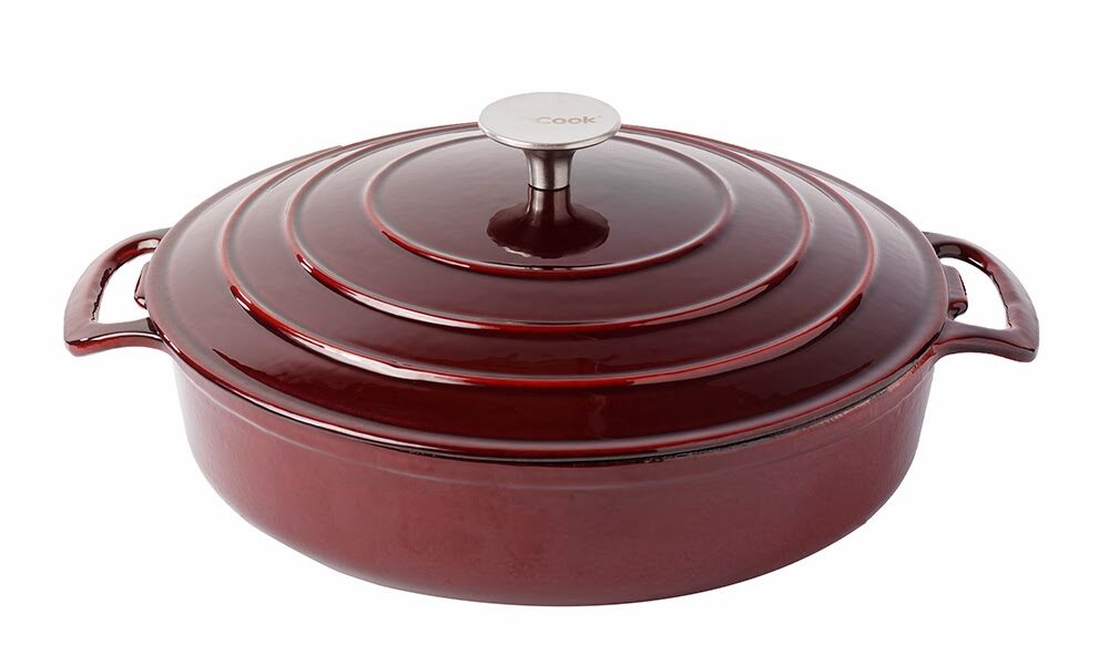 A deep, round, dark red enamelled cast iron casserole dish with two side handles and a matching lid. The lid has concentric ridges and a silver knob on top. The dish sits on a white background.