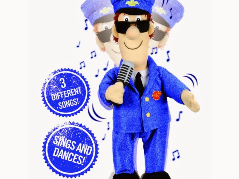 A soft toy dressed as a blue-uniformed train conductor holds a microphone, with musical notes and motion blur suggesting movement. Speech bubbles read “3 different songs!” and “Sings and dances!” on a plain white background.