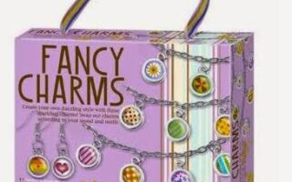 A purple “Fancy Charms” craft kit box with colourful charm designs shown on necklaces. The box features photos of two smiling girls and a warning label. A striped handle is attached at the top. The brand “4M” appears in the bottom right corner.