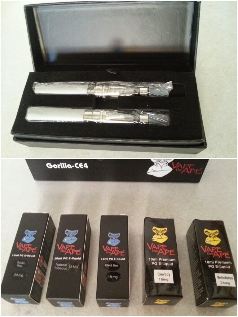 The image shows two vape pens in a black case above five boxes of Vape N Ape e-liquids in various flavours and nicotine strengths, including Natural Tobacco, Grape, Cowboy, and Menthol Madness, displayed on a light surface.