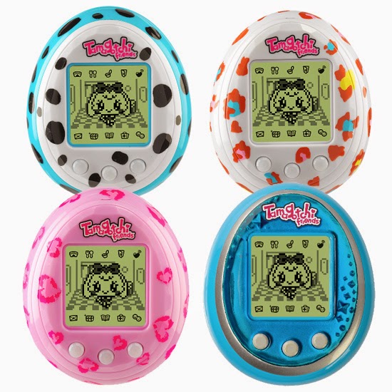 Four Tamagotchi Friends digital pets are displayed, each with a unique egg-shaped shell. The shells are white with black spots, white with colourful spots, pink with hearts, and blue with silver. All screens show a pixelated pet character.