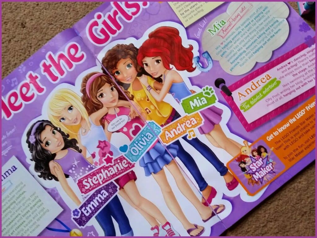 A colourful magazine page introduces five LEGO Friends characters—Emma, Stephanie, Olivia, Andrea, and Mia—standing together and smiling. Each character’s name appears on a decorative label near them, with text bubbles describing their personalities.