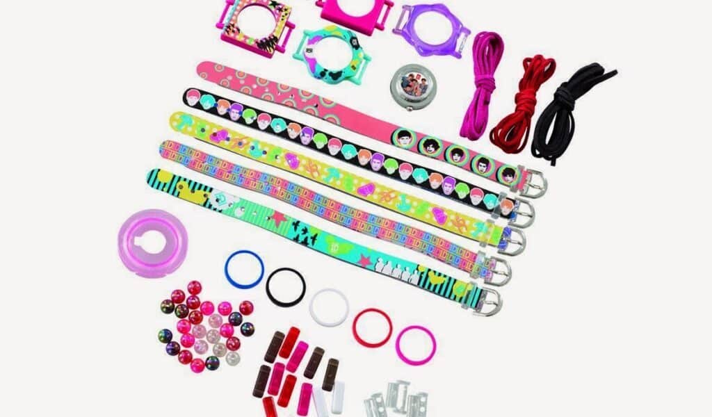 Colourful DIY bracelet kit with patterned wristbands, watch faces, strings, plastic beads, rings, clasps, and connectors arranged neatly on a white background. The set includes various colourful components for creative customisation.