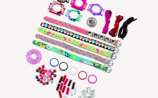Colourful DIY bracelet kit with patterned wristbands, watch faces, strings, plastic beads, rings, clasps, and connectors arranged neatly on a white background. The set includes various colourful components for creative customisation.