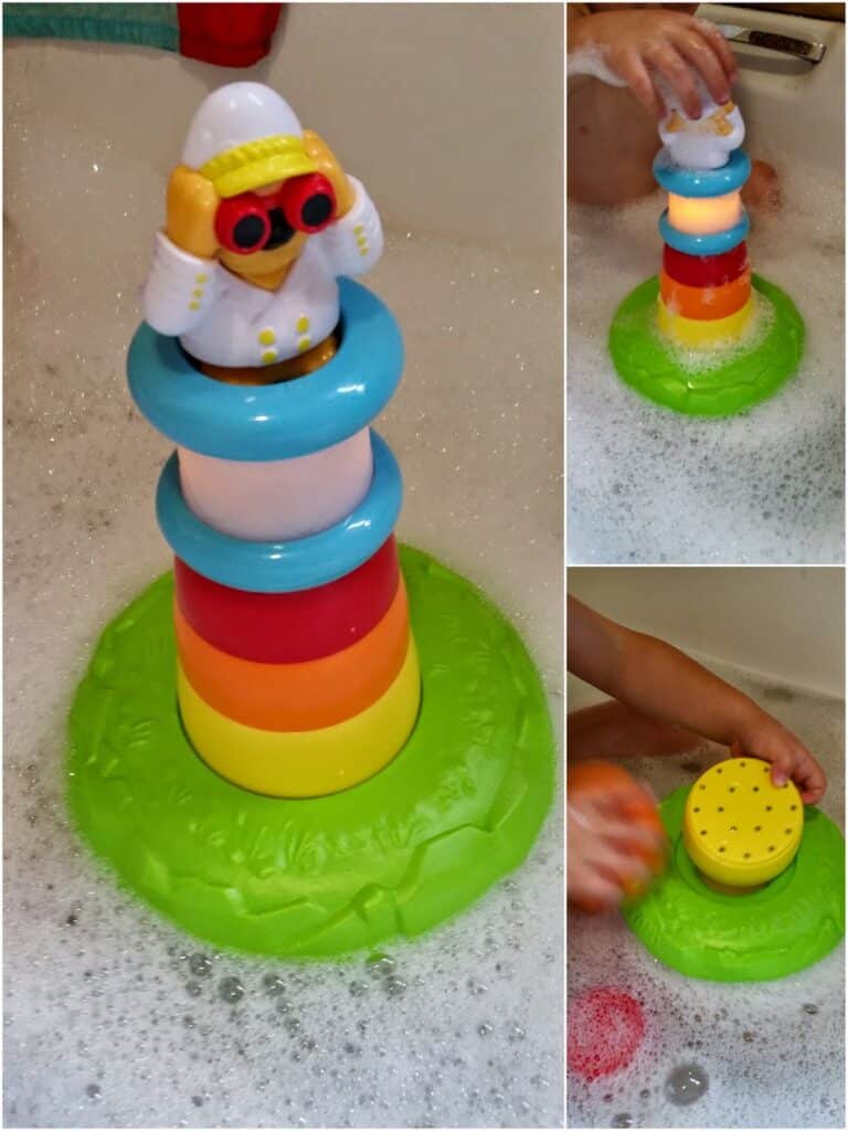 A colourful stacking bath toy sits in bubbly water. The main image shows a stack of rainbow rings with a white astronaut figure on top on a green base. The side images show a child’s hands stacking and holding the toy whilst playing in the bath.