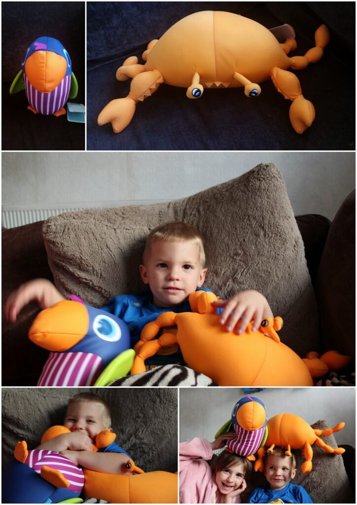 A collage of five photos shows two children interacting with large colourful plush toys shaped like a crab and bird on a sofa. The children, smiling and relaxed, cuddle and play with the toys, which are orange for the crab and multicoloured for the bird.