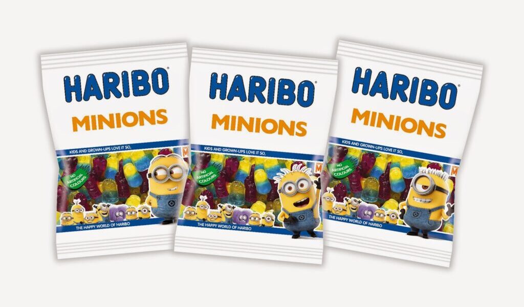 Three bags of HARIBO Minions gummy sweets are displayed side by side. Each white bag features colourful gummy sweets and images of Minions characters from the "Despicable Me" films on the front, with "HARIBO MINIONS" written in bold blue and yellow letters.