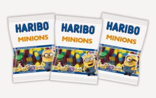 Three bags of HARIBO Minions gummy sweets are displayed side by side. Each white bag features colourful gummy sweets and images of Minions characters from the "Despicable Me" films on the front, with "HARIBO MINIONS" written in bold blue and yellow letters.