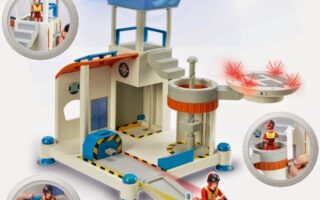 Toy rescue station playset with a control tower, rotating helipad, watercraft, and figurines in red uniforms. Small inset images show action features: figure riding watercraft, using lift, sitting in station, and helipad with red lights. Blue light on tower.