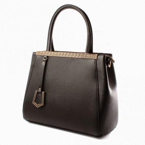 A black leather handbag with two handles, gold Greek key trim along the top edge, and a gold accent tag hanging from one handle. The bag has a smooth texture and a structured, trapezoidal shape. The background is plain white.
