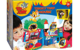 Colourful "Tom & Jerry Tricky Trap House" toy box for ages 3+, featuring images of a boy and girl playing, cartoon Tom and Jerry characters, trap features like “Kaboom!” and “Oops”, and a playful house toy inside.