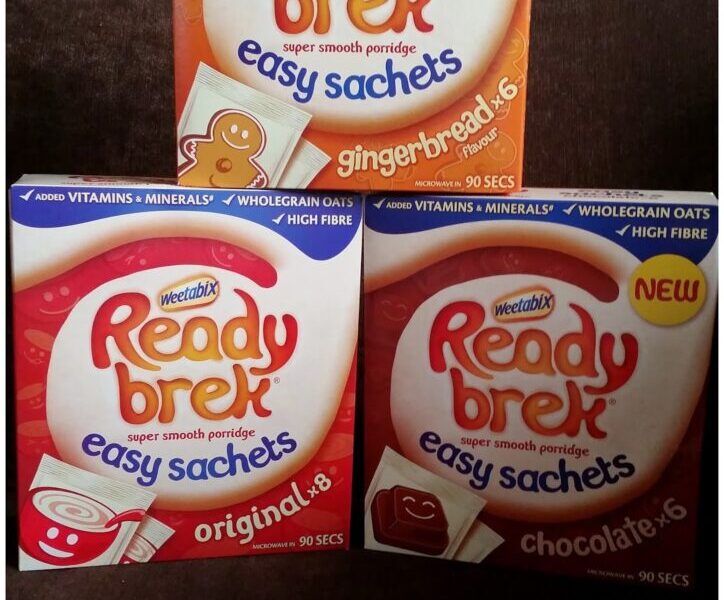 Three boxes of Ready Brek easy sachets porridge are shown: gingerbread flavour (orange box, top), original flavour (red box, bottom left), and chocolate flavour (red box, bottom right), all featuring porridge bowl images on the front.