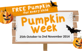 A sign with pumpkins, bats, spiders, and webs advertises "Pumpkin Week" from 25th October to 2nd November 2014, with a banner stating "FREE Pumpkin for every child" in bright orange and white text.
