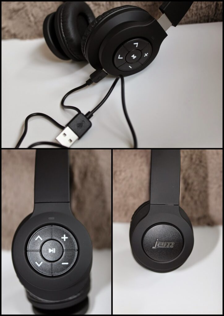 A black over-ear headset with padded ear cups and a built-in control panel featuring play, pause, and volume buttons. One ear cup has a "jam" logo; a USB charging cable is attached. The headset is shown from various angles on a white surface.
