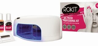 A ROKIT Gel Polish Professional Kit showing a UV lamp, remover, ready and gel polish bottles, a nail file, and buffer in front of the product box, which features a woman with a hand over her face and pink nails.