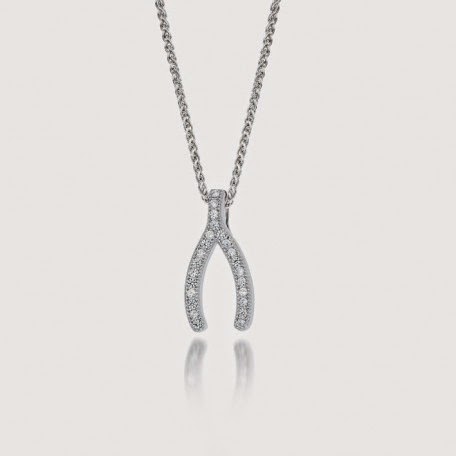 A delicate silver necklace with a wishbone-shaped pendant, encrusted with small sparkling diamonds, hangs from a fine chain against a plain white background. The pendant’s two arms curve gently outward, creating a simple, elegant look.