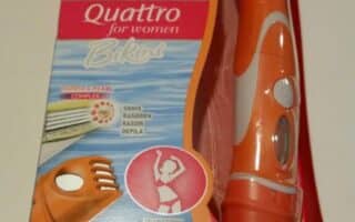 A pink and orange box of Wilkinson Sword Quattro for Women Bikini razor. The packaging shows the razor inside, with a trimmer and blade visible. Text highlights its 2-in-1 use for shaving and trimming, with images demonstrating both functions.