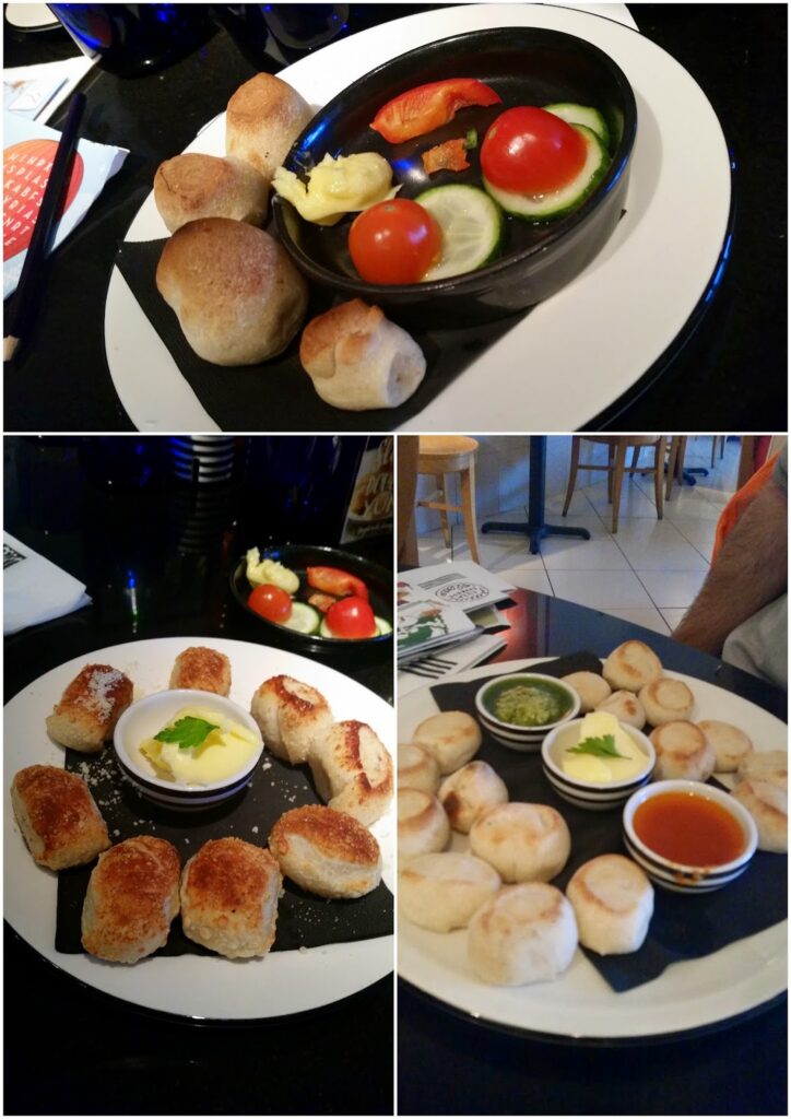A collage of three images shows plates of small, round bread rolls. The top image has rolls with butter, sliced cucumber, and tomato. The bottom left has browned rolls with butter and herbs. The bottom right shows rolls with dips: green sauce and reddish-orange sauce.