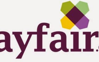 Wayfair.co.uk logo. The word "wayfair" is in lowercase, bold, purple text. Above the letters "a" and "i" is a geometric flower-like icon with green, purple, and yellow shapes. "co.uk" appears in smaller grey letters on the right.