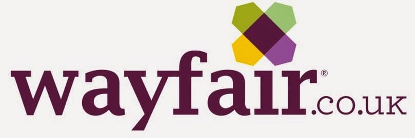 Wayfair.co.uk logo. The word "wayfair" is in lowercase, bold, purple text. Above the letters "a" and "i" is a geometric flower-like icon with green, purple, and yellow shapes. "co.uk" appears in smaller grey letters on the right.