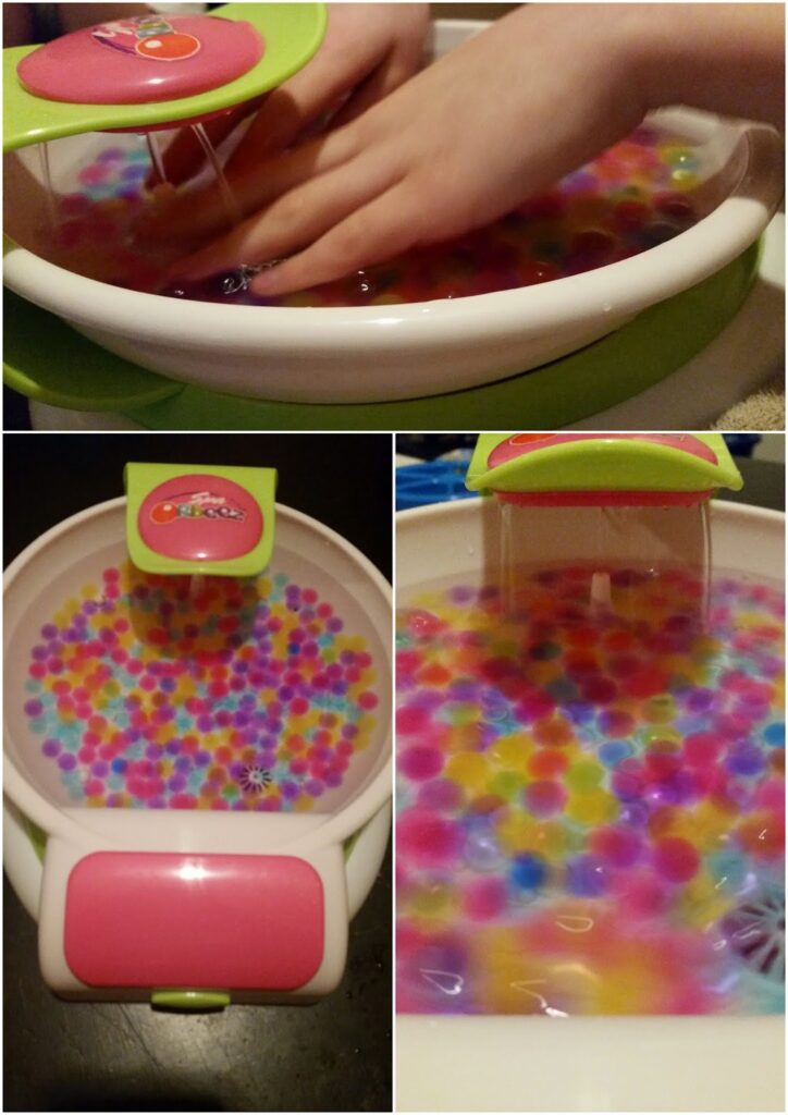 A collage of three images shows a children’s foot spa filled with water and colourful water beads. The top image shows hands reaching into the spa under running water; the bottom images show close-ups of the beads and spa features in pink, white, and green.