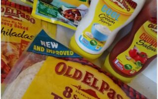 Assorted Old El Paso products including fajita seasoning, enchilada kit, Cool Soured Cream Topping, Chunky Salsa, and a large pack of 8 super soft flour tortillas are arranged together, with bright packaging and distinct yellow branding.