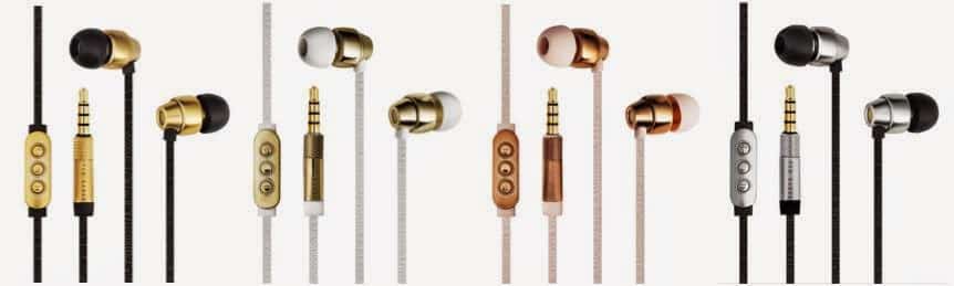 Four pairs of wired in-ear earphones are shown in a row, each with a different colour scheme: black and gold, white and gold, rose gold and beige, and black and silver. All have built-in control buttons and standard 3.5mm audio jacks.