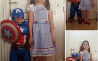Two children pose indoors in front of a white door. One is dressed as Captain America, wearing a mask and holding a shield, and the other is dressed as Dorothy from "The Wizard of Oz" with a blue gingham dress and red shoes. Three photos show different poses and smiles.