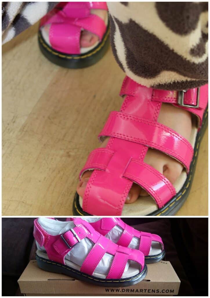 Two photos of shiny pink Dr. Martens sandals. The top image shows a close-up of someone wearing them on a wooden floor. The bottom image displays the sandals unworn, placed on a Dr. Martens shoe box, highlighting their bright colour and buckled straps.