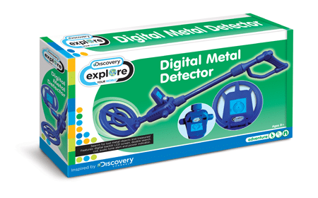 A green and white box features a blue digital metal detector toy. The front displays "Digital Metal Detector" and "Discovery explore" branding, with an image of the detector and a screen close-up. The box is for ages 8+ and says "Inspired by Discovery.
