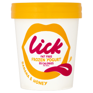 A white tub of Lick fat free frozen yoghurt with a bright yellow lid. The label features yellow-orange lips, bold pink text saying "lick," and states "Fat Free Frozen Yoghurt, 83 Calories per 100ml." Flavour: Banana & Honey.