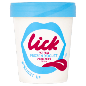 A white tub of Lick frozen yoghurt with a blue lid. The label shows blue lips, the word "lick" in red, and text reading "Fat Free Frozen Yoghurt, 79 Calories per 125ml." A red splash graphic and "Straight Up" are also on the container.