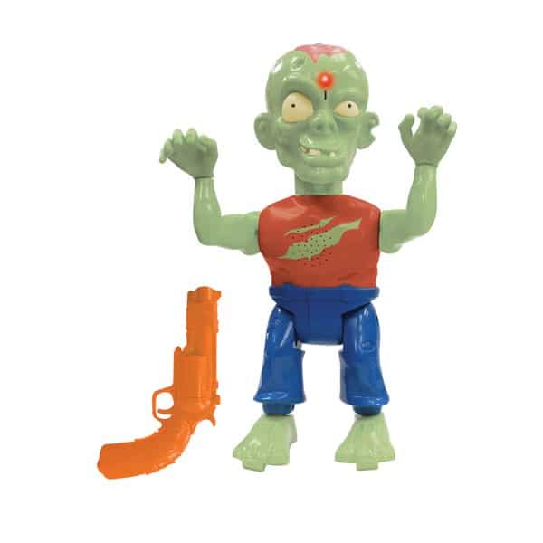 A green zombie toy with bulging eyes, a red dot on its forehead, and a red shirt with a green graphic, blue trousers, and raised arms. Next to it is an orange toy gun. Both items are on a white background.