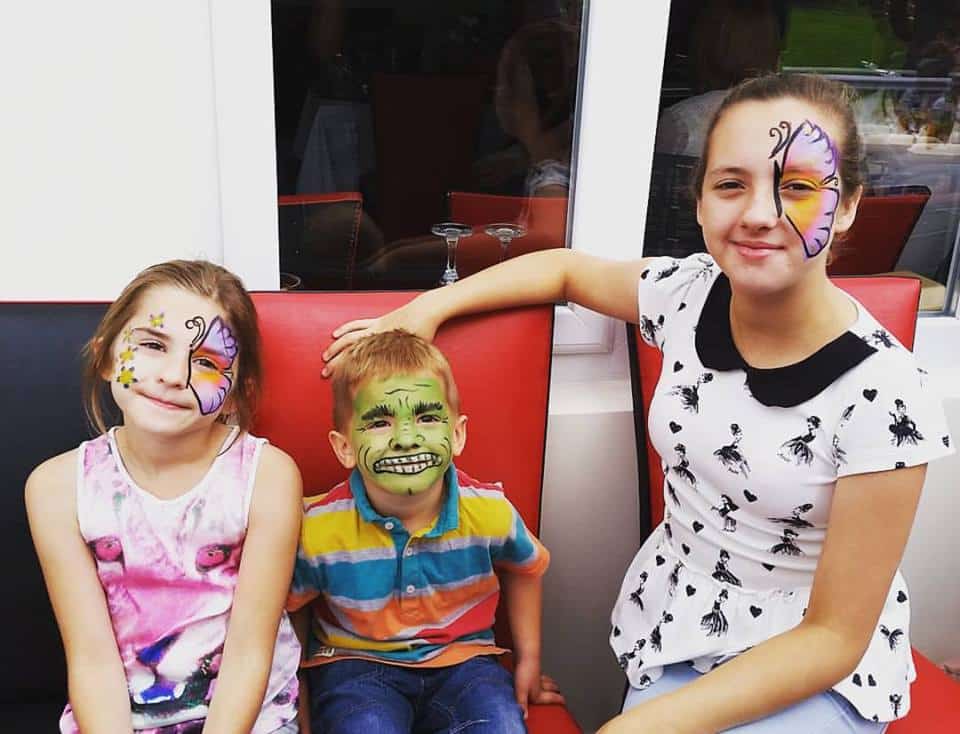 A group of children with face paint.