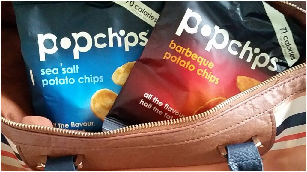 A bag of crisps in a handbag.